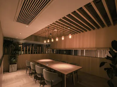 Industrial-style restaurant interior with wooden tables and concrete accents