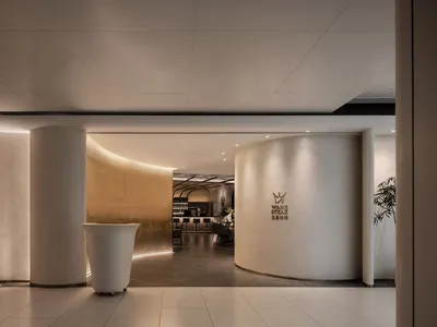 Modern restaurant entrance with concrete columns and ambient lighting