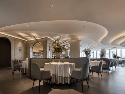 A modern elegant dining room with soft lighting and contemporary furniture.
