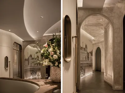 A modern restaurant interior with plaster walls and floral decorations.