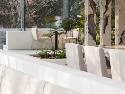 Contemporary restaurant lounge with marble finishes and green plants
