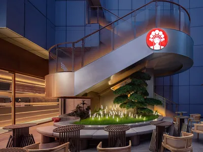 Modern restaurant bar with concrete, wood, and cushioned seating