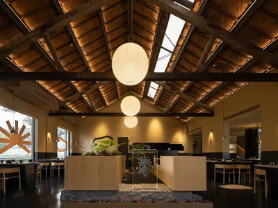 An industrial-style restaurant interior with wooden and bamboo elements