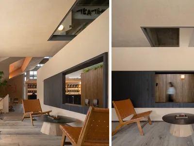 Modern indoor space with concrete walls, wooden seating, and a circular table.