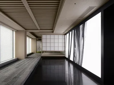 Modern interior design featuring a glass panel with abstract black and white image in a hotel lobby.