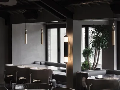 Industrial-style restaurant interior with metal, glass, and concrete materials.