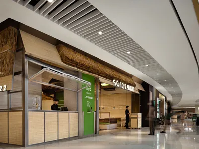 A minimalist restaurant interior featuring bamboo elements and green accents.
