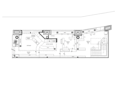 A detailed architectural floor plan of a coffee shop featuring a concrete floor, glass display cases, and a wooden seating ar