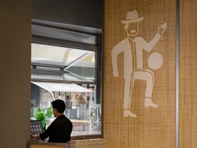A modern restaurant interior featuring woven fiber materials and contemporary design elements.