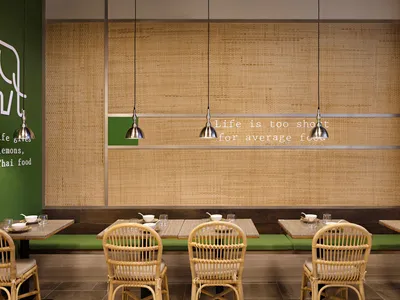 Cafe interior with bamboo, natural furniture, and metal accents