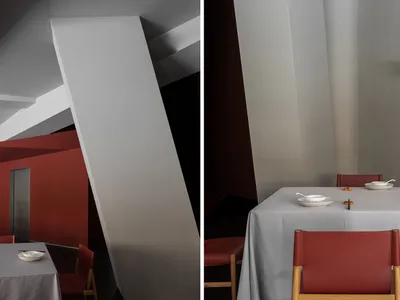Modern restaurant interior with gray fabric walls and tables, showcasing contemporary design features.