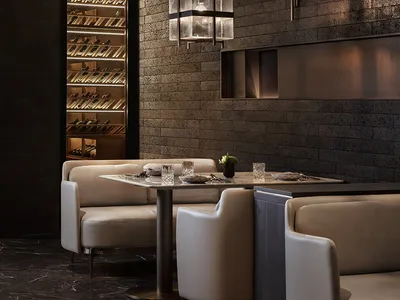 Industrial-style restaurant interior with brick walls and leather seating.
