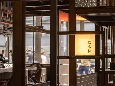 Industrial-themed restaurant interior with wooden walls and lighting fixtures