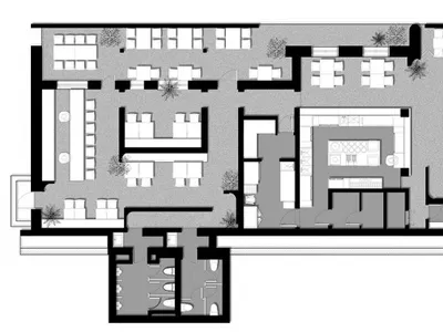 Modern restaurant bar floor plan with neutral-colored concrete floor and seating areas.