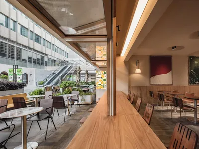 Modern cafe interior featuring wood and glass elements.
