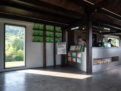 A modern café counter featuring concrete and wood materials.