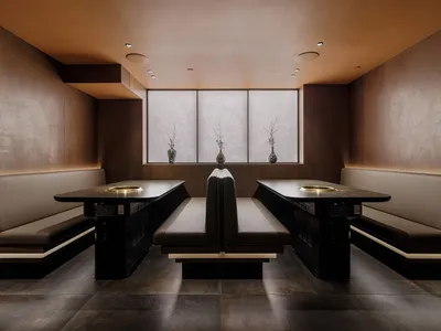 Industrial-style restaurant interior featuring concrete, wood, and metal materials.