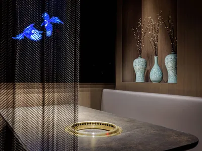 A modern restaurant interior with metal and leather elements.