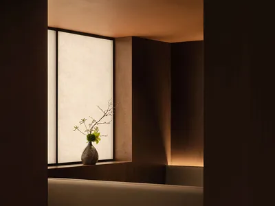 A minimalist restaurant booth featuring wooden seating and paper walls.