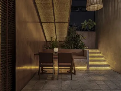 Close-up of a modern restaurant booth featuring wooden materials and warm lighting.