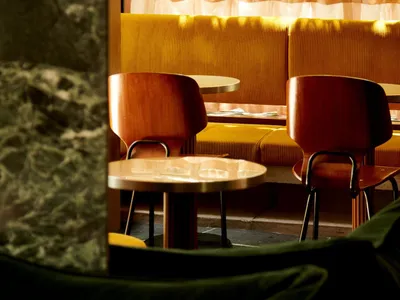A cozy cafe interior with wooden furniture and seating.