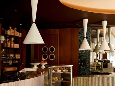 A modern restaurant interior featuring concrete and marble materials.