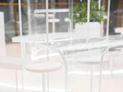Clear acrylic restaurant counter with modern design and seating.