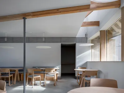 Industrial-style restaurant interior with wooden furniture and concrete flooring