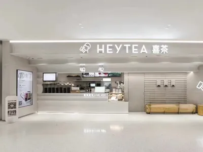 Modern restaurant interior with minimalist design featuring predominantly white materials.