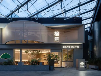 Modern restaurant exterior with glass facade and concrete accents