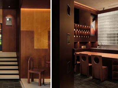 A modern restaurant interior featuring wooden paneling and natural light.