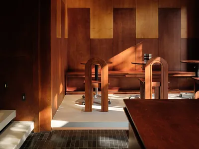 Modern restaurant interior with wooden walls and furniture
