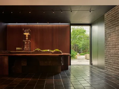 Industrial-themed restaurant interior with metal accents, glassware, and concrete finishes.