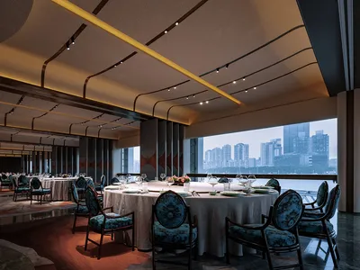 A modern restaurant interior featuring fabric seating, glass windows, and wooden accents.
