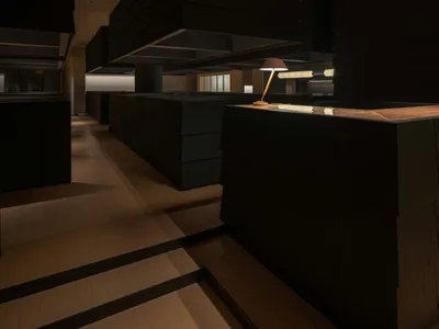 Modern restaurant interior with dark wood and concrete elements