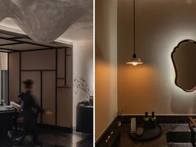 A modern restaurant interior with minimalist design elements, featuring wooden partitions, metal accents, concrete floor, and