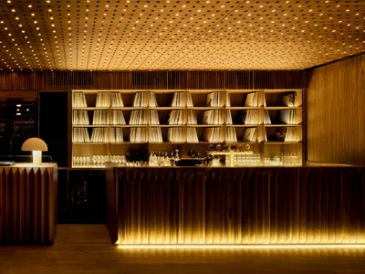 Industrial style restaurant bar with wooden counter and lighting