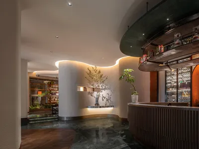 Modern restaurant interior with metallic segundo marble flooring and sleek, contemporary decor.
