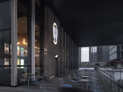 Modern restaurant exterior featuring metallic design, glass walls, and concrete base.