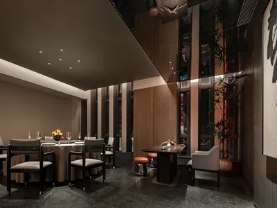 Modern restaurant interior with concrete walls, wooden furniture, and glass elements.