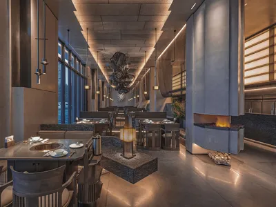 Modern restaurant interior featuring metal, wood, and stone materials.