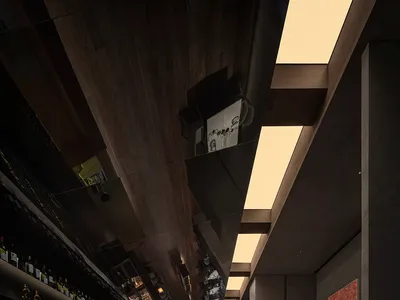 A restaurant bar featuring a wooden ceiling and industrial design elements.