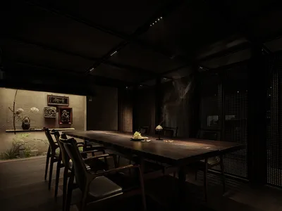 Industrial-style restaurant interior with dark wood tables and chairs, minimal lighting, and decorative elements.