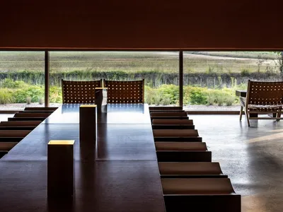 Modern restaurant dining room featuring sleek metallic design elements