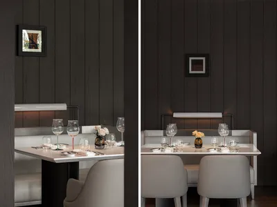 A modern restaurant interior with a white table setting on a wooden surface.