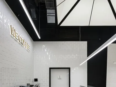 Modern minimalist cafe interior with white tiles and metallic fixtures
