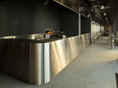 A sleek, stainless steel restaurant counter with a minimalist design.