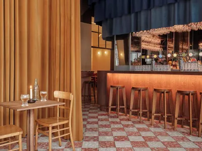 Interior of an industrial-themed restaurant featuring copper, leather, and wooden materials