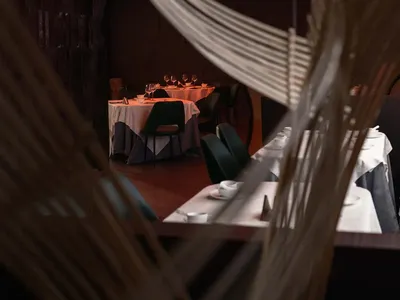 Interior view of an industrial-themed restaurant showcasing metallic textiles as a feature.