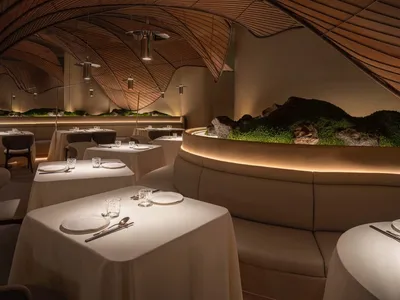 A modern restaurant interior with wooden materials and a sophisticated design.